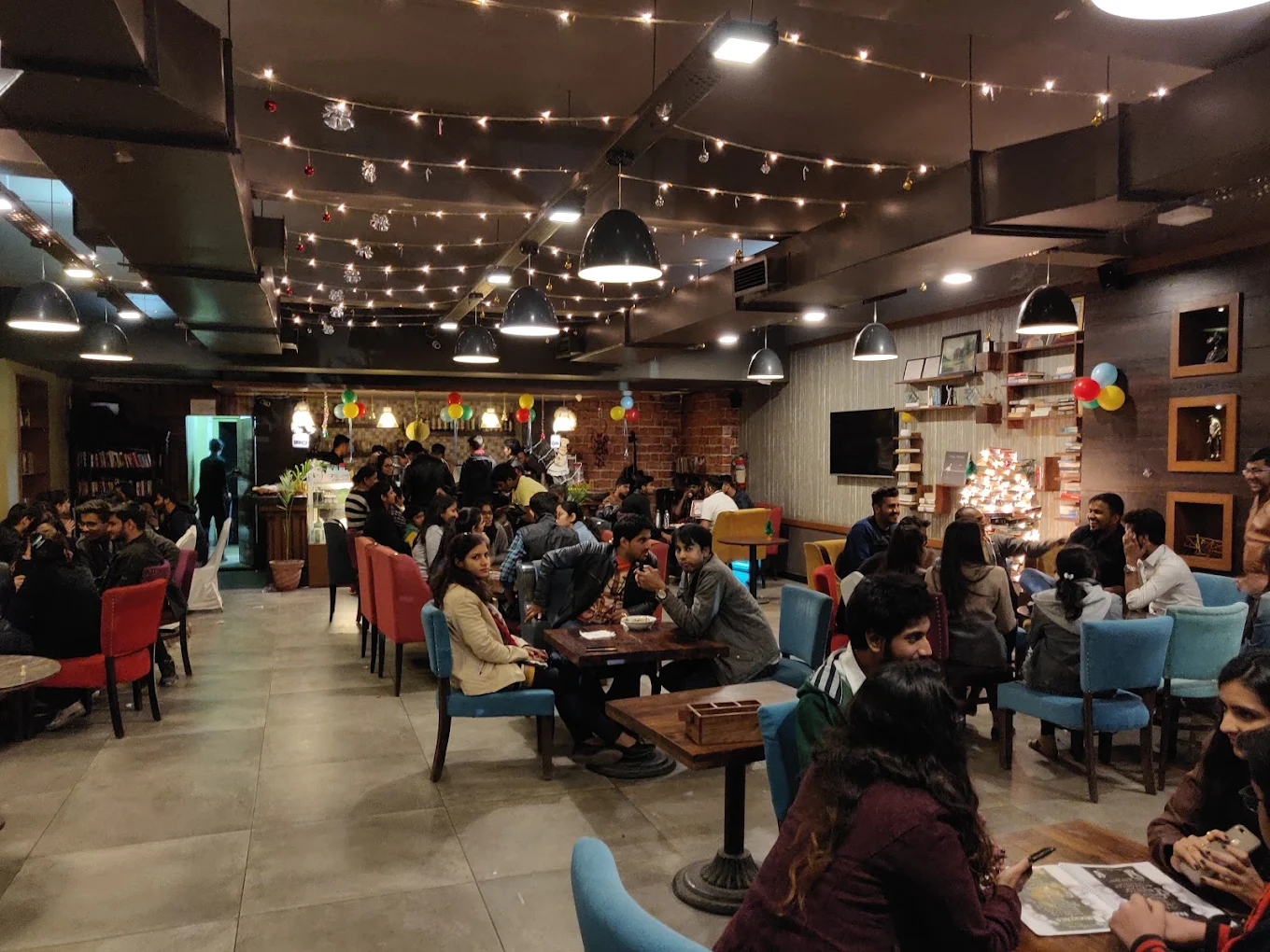 Book cafe filled with people and warm lights